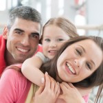 Dental Implant Specialist: Family with Healthy Teeth