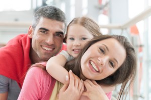 Dental Implant Specialist: Family with Healthy Teeth